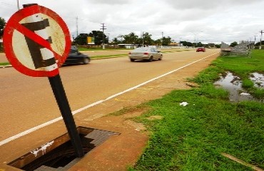 CENA DA CIDADE – Bueiro com tampa quebrada e placa de sinalização em seu interior deixa pedestres em risco - FOTOS