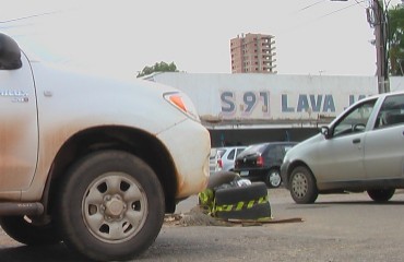 Buraco no centro da cidade causa transtornos a comerciantes e prejudica tráfego; pneus servem de sinalização para os motoristas